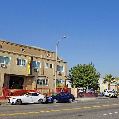 The image shows a street with parked cars, a two-story beige building, and a McDonald's sign and ad in the background.